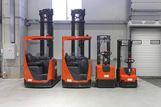 forklifts maneuvering through a busy warehouse